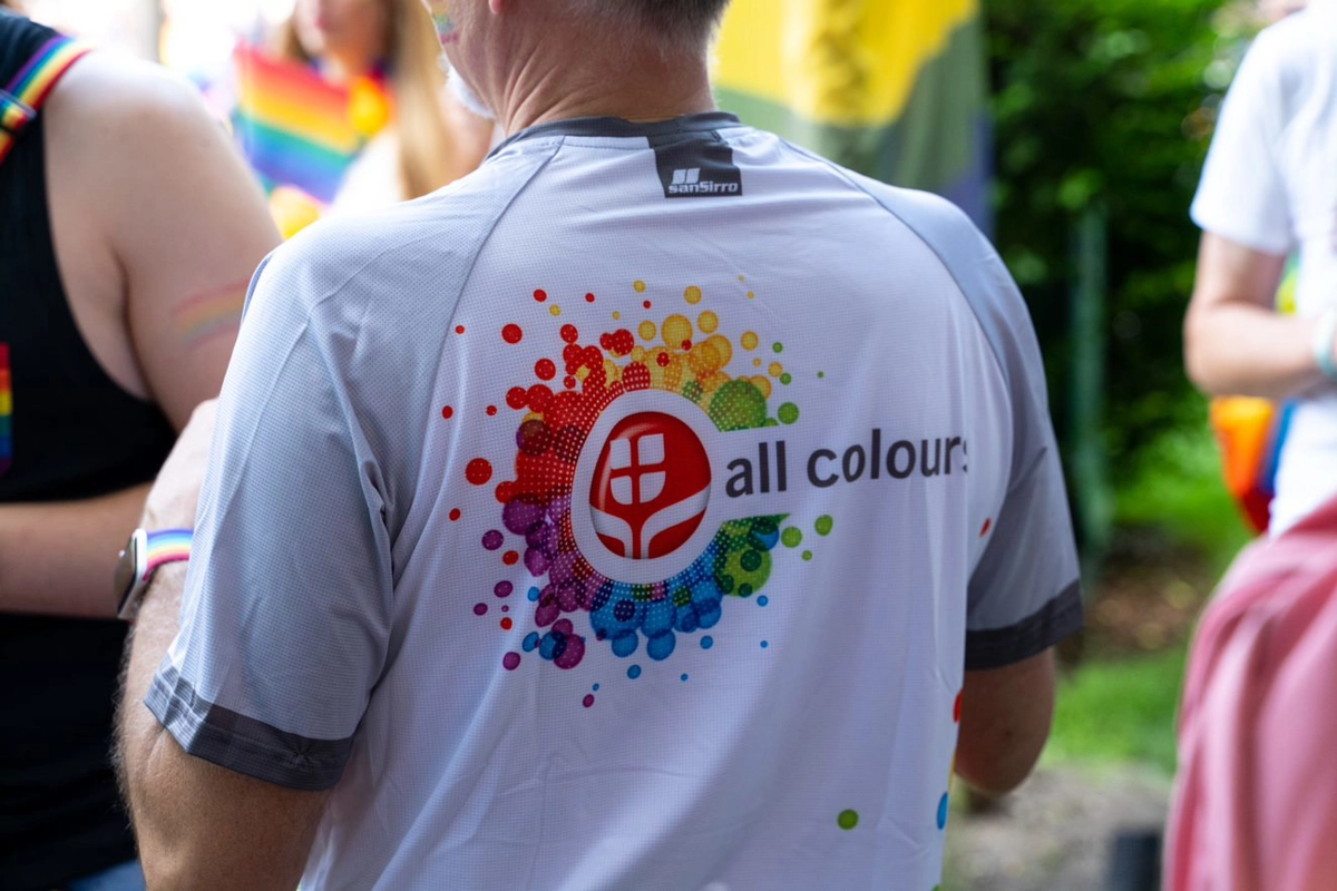 Person is wearing an all colours t-shirt